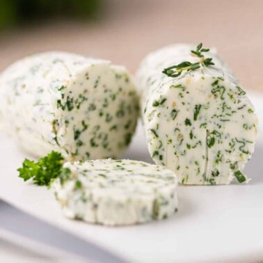 cylindrical roll of herb butter (compound butter)