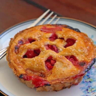 A plate of food with a fork, with Apple rhubarb Pie