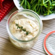 homemade condensed cream of mushroom soup in glass jar with sprig of thyme