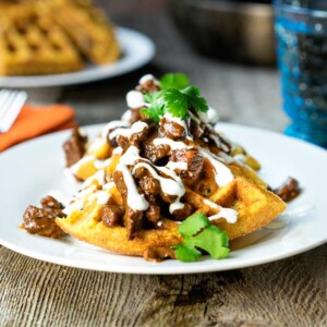 plate of cornmeal waffles topped with bbq beef