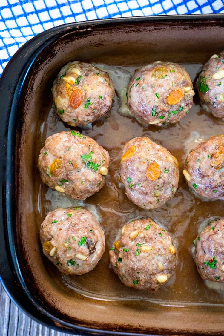 These Roman Meatballs have pine nuts, golden raisins, red pepper flakes, herbs and cheeses, then are simmered in a zesty and spicy Arrabbiata Sauce. So good! www.keviniscooking.com
