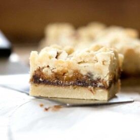 Caramel Butter Bars. A buttery shortbread bar cookie, chocolate and caramel. The crumble topping with slivered almonds covers the decadent filling. www.keviniscooking.com