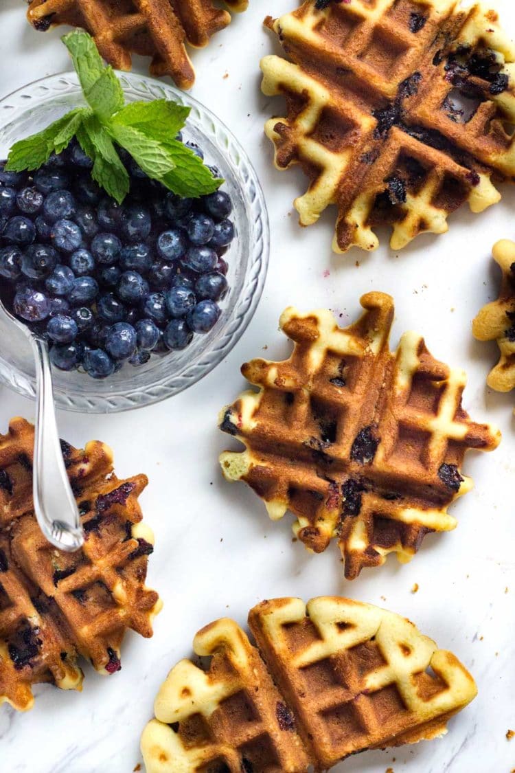 Fresh, warm Blueberry Poundcake Waffles served up. These tender and buttery waffles are laced with fresh berries, a great way to start your day! www.keviniscooking.com