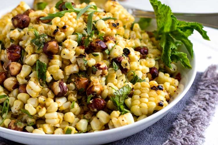 A plate of food with corn Hazelnut and Salad