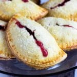 These Rhubarb Baked Empanadas are baked, not fried and the lightly sweet, flakey dough is just perfect to hold the chopped rhubarb and strawberries. Perfect for the kids and picnics. www.keviniscooking.com