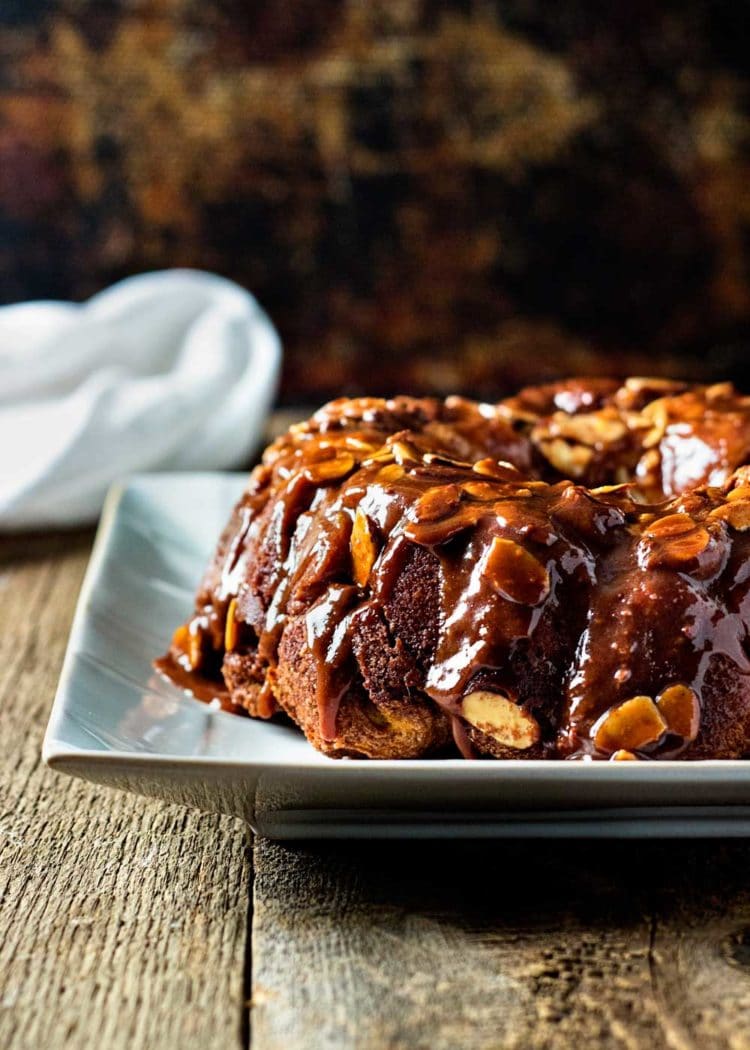 This Chocolate Caramel Monkey Bread is made with refrigerated biscuit dough and few pantry ingredients, Wrap, dunk, roll and bake - you're set! www.keviniscooking.com