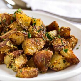 These Herb Roasted Poupon Potatoes couldn't be any easier. Caramelized red potatoes that are crispy on the outside all coated with a tangy sauce. www.keviniscooking.com