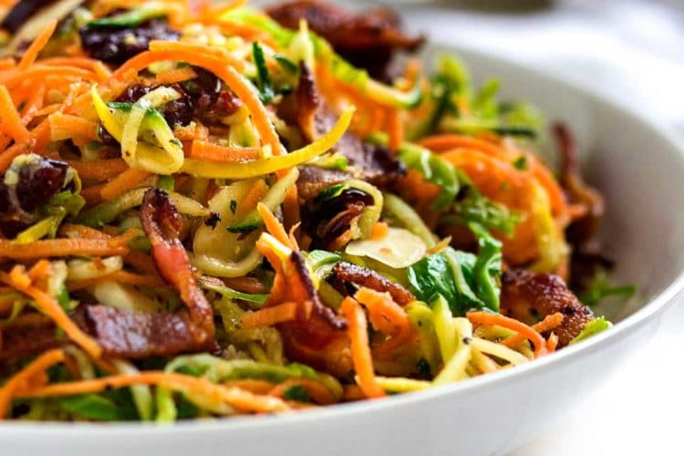 This Honey Mustard Sweet Potato Salad is made with with spiralized sweet potatoes, zucchini and shaved brussels sprouts in a bacon honey mustard dressing that is off the hook in taste and made in no time! www.keviniscooking.com