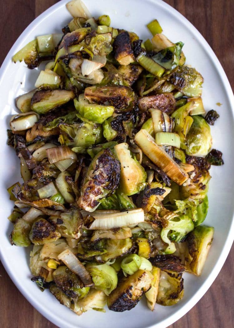 These Pan Roasted Brussels Sprouts are served crispy, browned and get a flavor boost from sliced leeks cooked with butter, fresh ginger and lime zest. www.keviniscooking.com