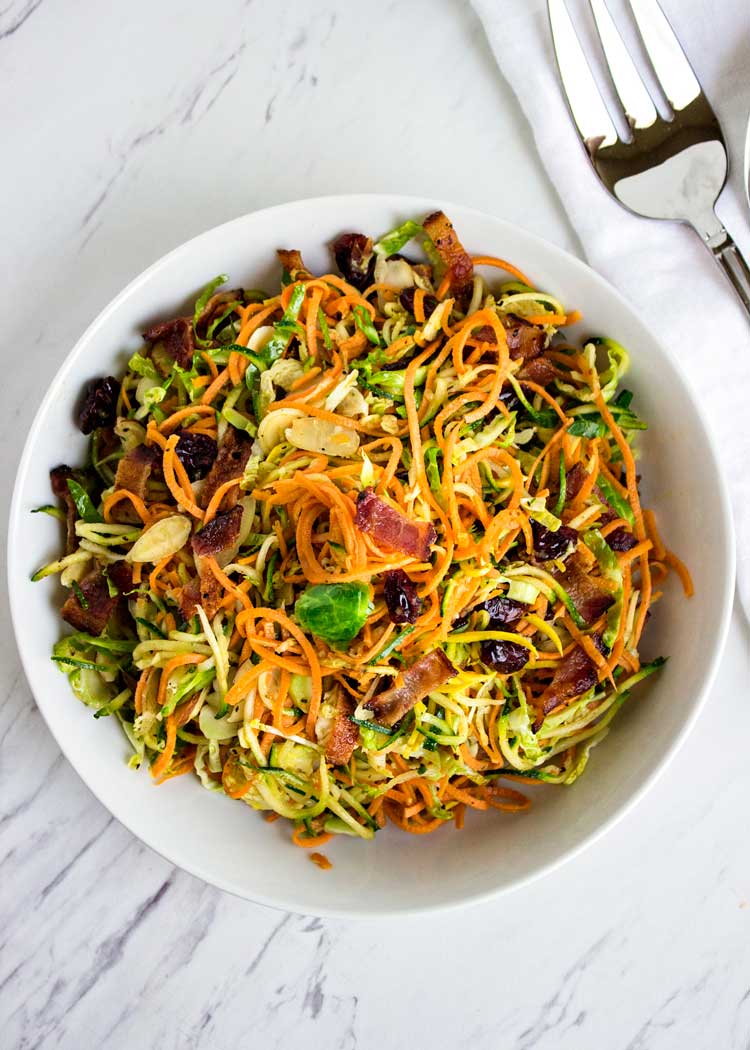 This Honey Mustard Sweet Potato Salad is made with with spiralized sweet potatoes, zucchini and shaved brussels sprouts in a bacon honey mustard dressing that is off the hook in taste and made in no time! www.keviniscooking.com