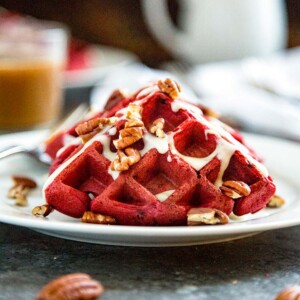 These Red Velvet Waffles with Cream Cheese Glaze are the perfect way to wake up your sweetie for Valentines Day breakfast or after a great dinner for dessert. These red chocolate fluffy waffles with a cream cheese glaze are a sure hit! keviniscooking.com