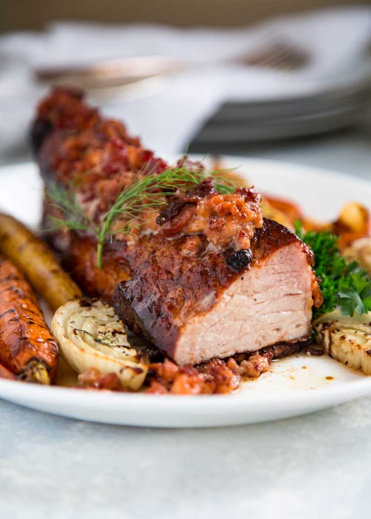 This Roasted Pork Loin Filet with Apples and Fennel is perfectly seasoned gets a quick pan sear then roasts with smoked bacon crumbles on top and is served with honey roasted apples and fennel. Ready in 30 minutes, too! keviniscooking.com