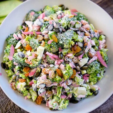 Tarragon Broccoli Salad with Golden Raisins, Marinated Red Onion and Pepitas - this fresh, crunchy and healthy salad is the perfect side dish! keviniscooking.com