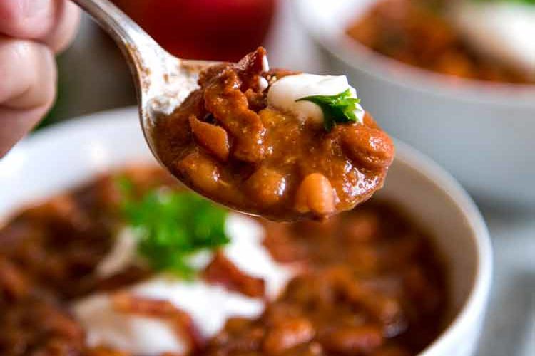 These Sweet and Spicy Baked Beans have a secret flavor weapon that may sound strange, yet is so good. Peaches and bacon pack the flavor in these "baked" beans. keviniscooking.com