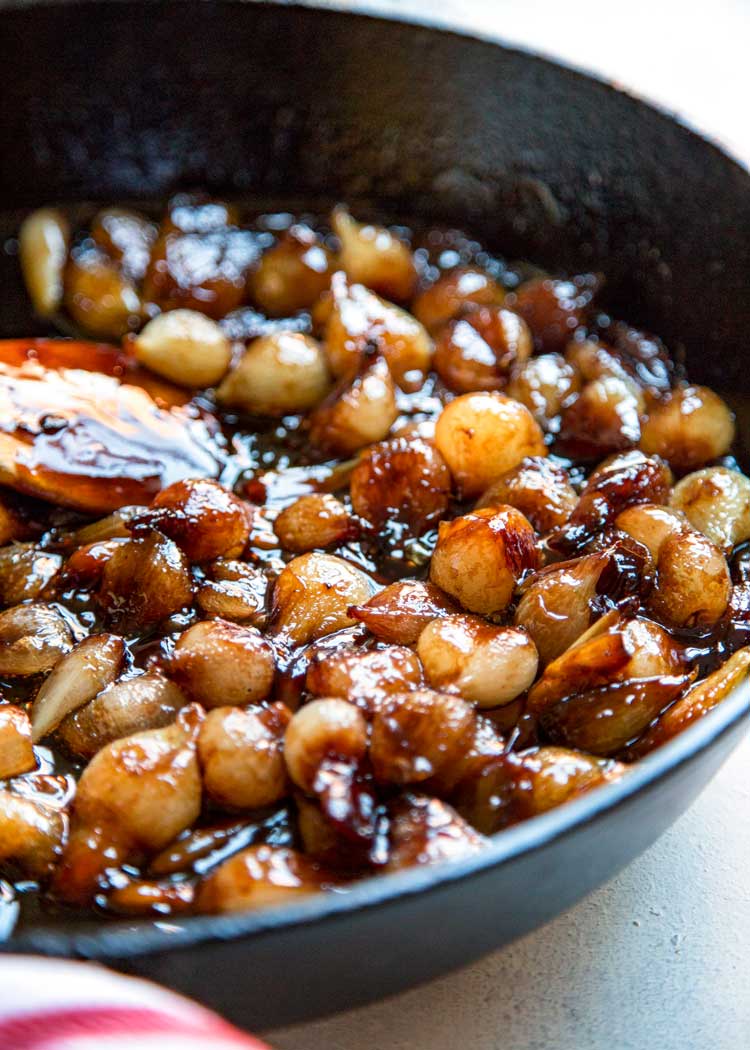 closeup: glazed pearl onions cooking in a skillet