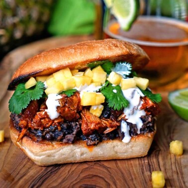 mexican sandwich with pulled meat, crema, cilantro and chopped pineapple