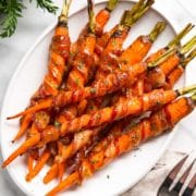 platter of large cooked carrots wrapped in bacon