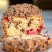 This tender Cranberry Nut Bread is the perfect way to wake up with a cup of coffee or tea. Loaded with cranberries and a crunchy cinnamon streusel topping. keviniscooking.com