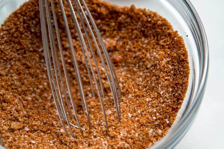 All Purpose BBQ Dry Rub in glass bowl with whisk