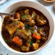 A bowl of Guinness stew with chunks of meat and vegetables