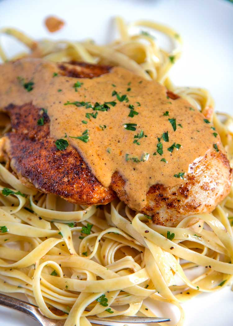 closeup: Chicken Lazone over linguine topped with sauce