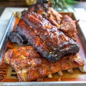 These Huli Huli Smoked Pork Ribs start with baby backs that are marinated overnight in pineapple juice, soy sauce, ginger, garlic and few other pantry items. Slowly smoked over mesquite to sticky sweet goodness.