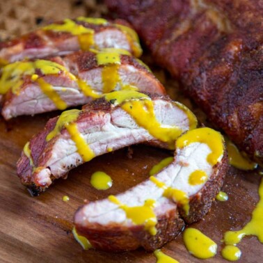 A close up of South Carolina pork ribs with mustard sauce