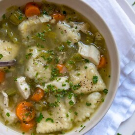 This beautifully seasoned Southern Chicken and Dumplings is made with shredded chicken, vegetables and is loaded with tender herb and buttermilk dumplings.