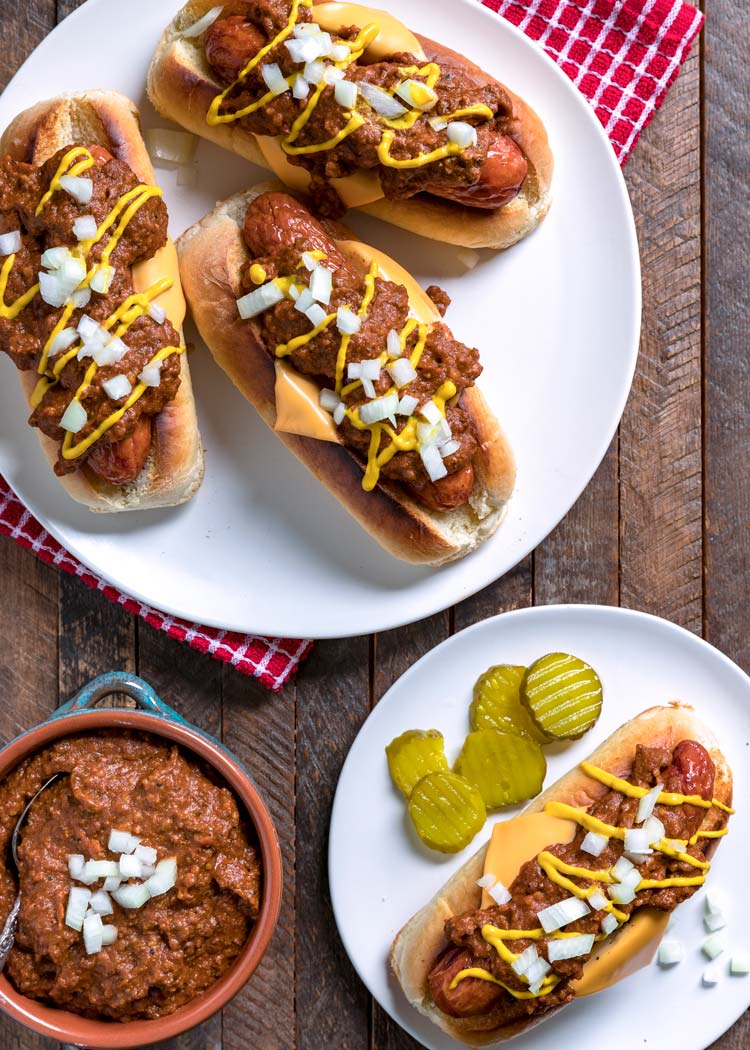overhead of 4 hot dogs with Instant Pot chili, cheese, onions, and yellow mustard