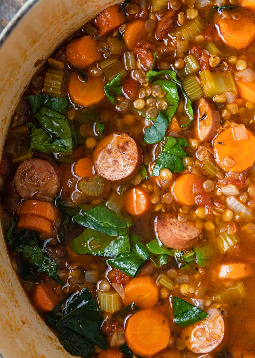 sausages, carrots and spinach in broth
