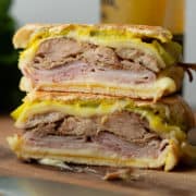 A close up of a cut Cuban sandwich stacked