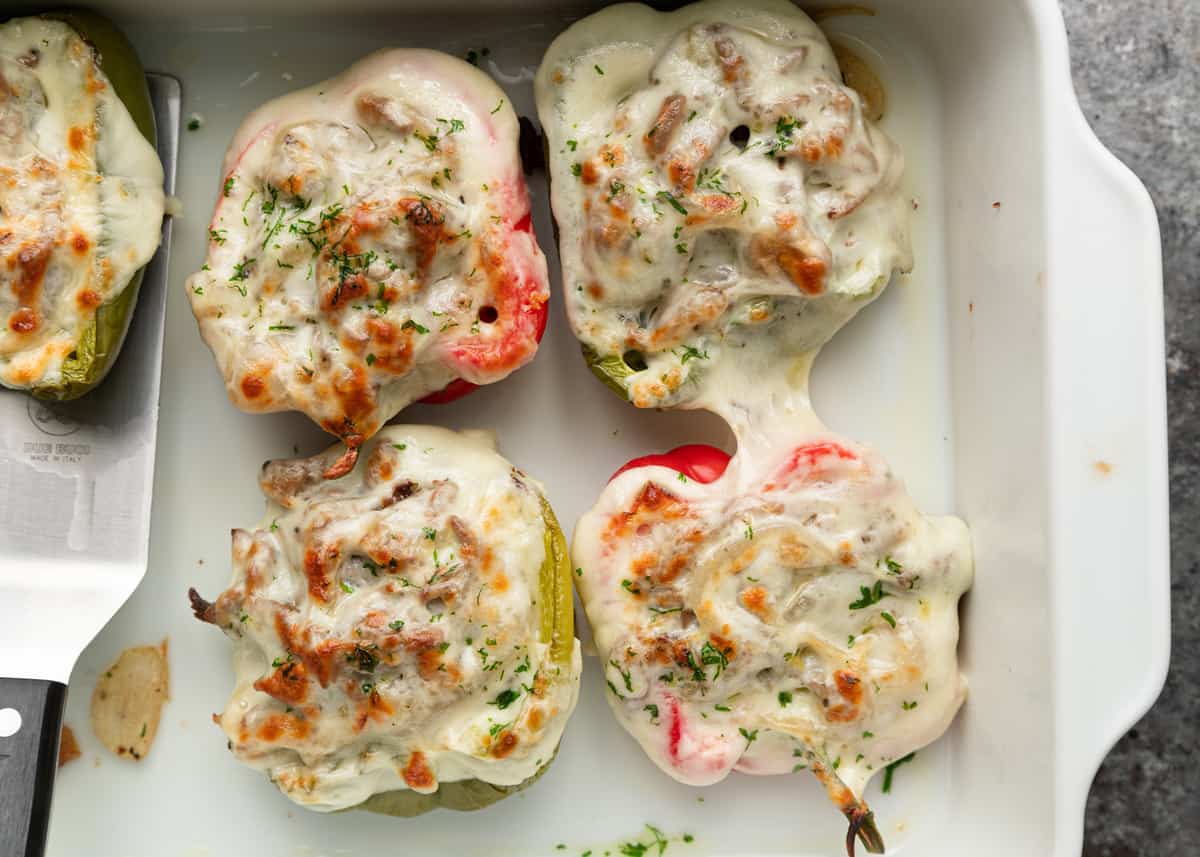 melted cheese over stuffed peppers