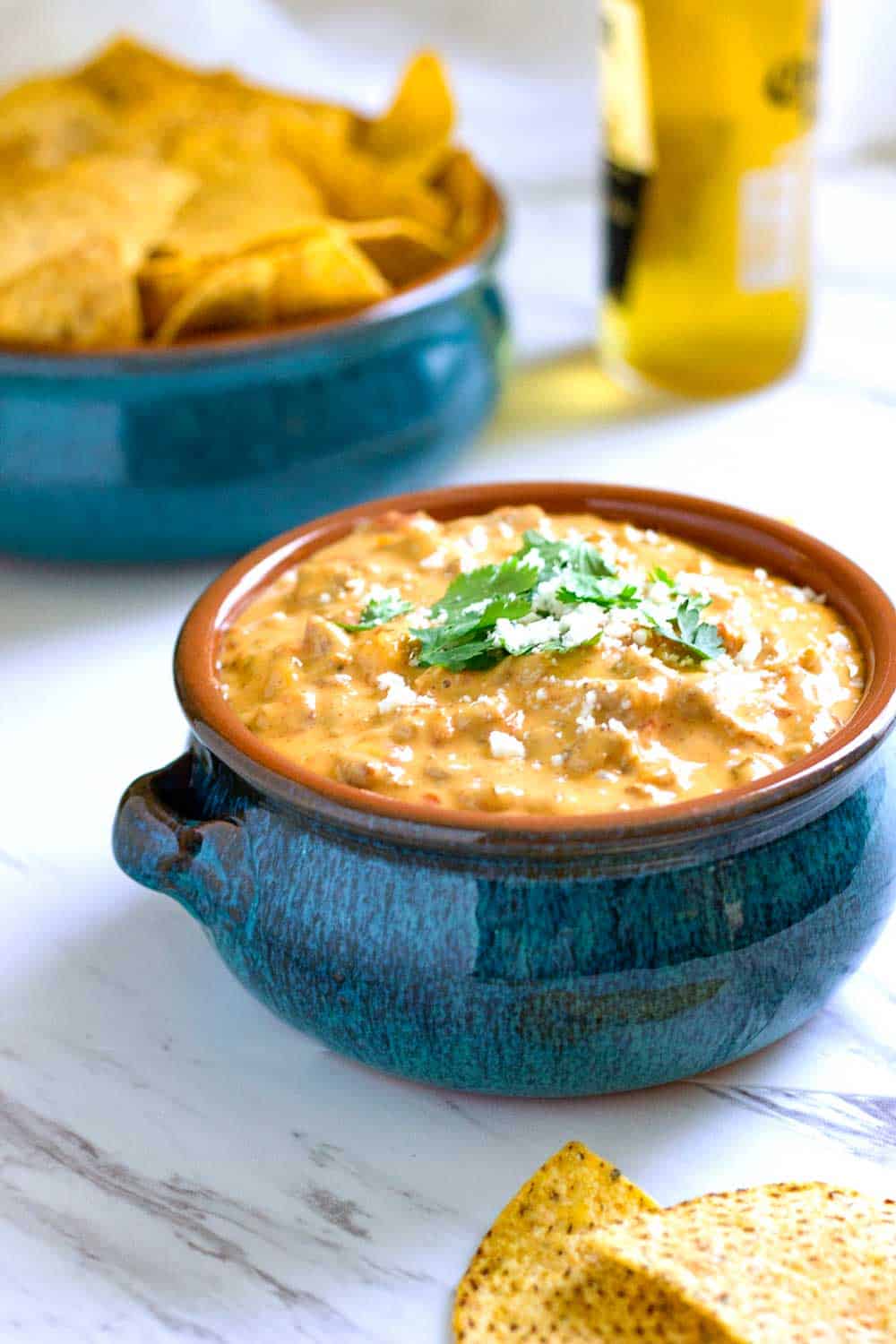 beef queso dip without Velveeta in a blue bowl