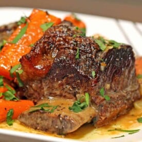 A close up of a plate of Beef short Ribs