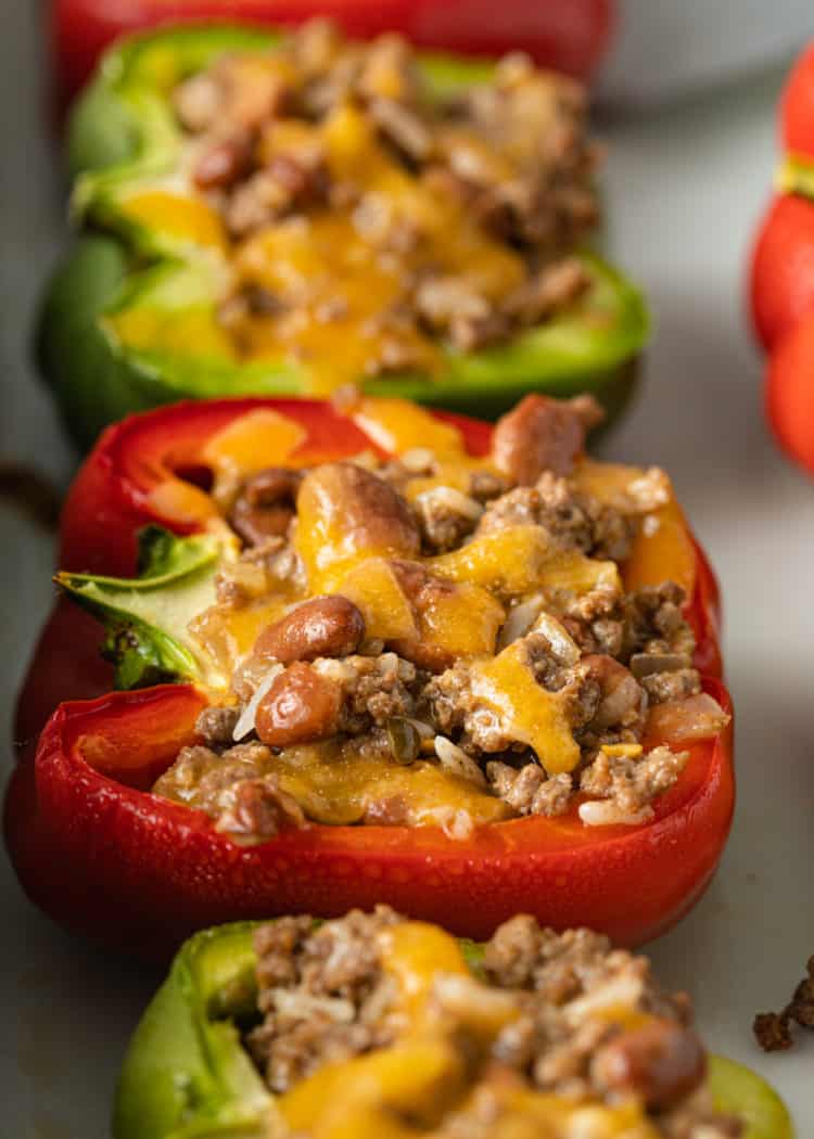overhead: mexican stuffed peppers in red and green bell peppers