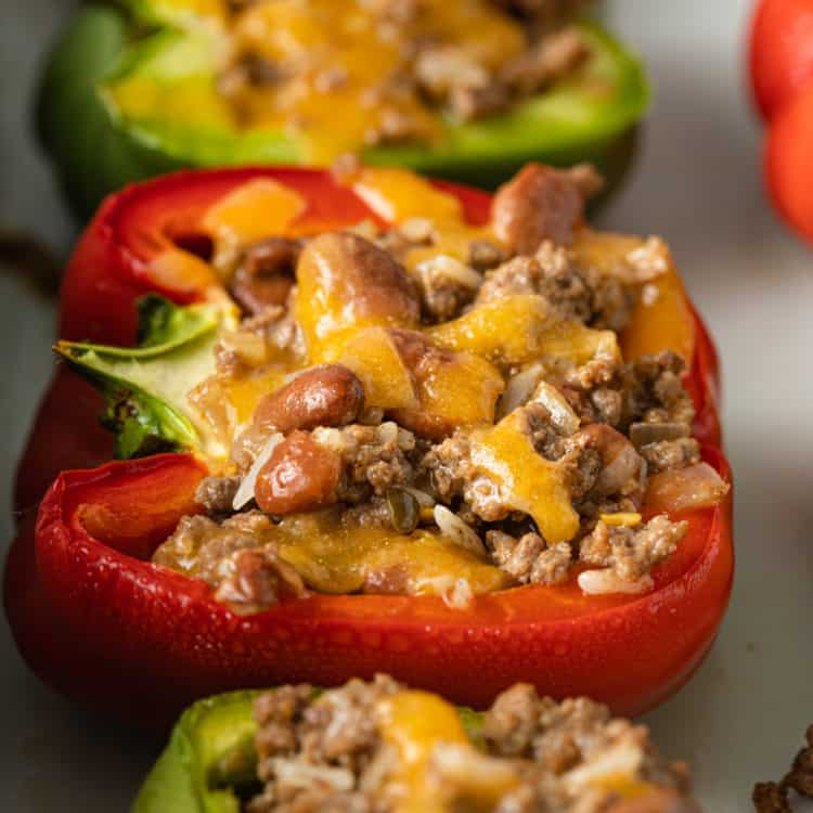 closeup: green and red bell peppers with meat filling