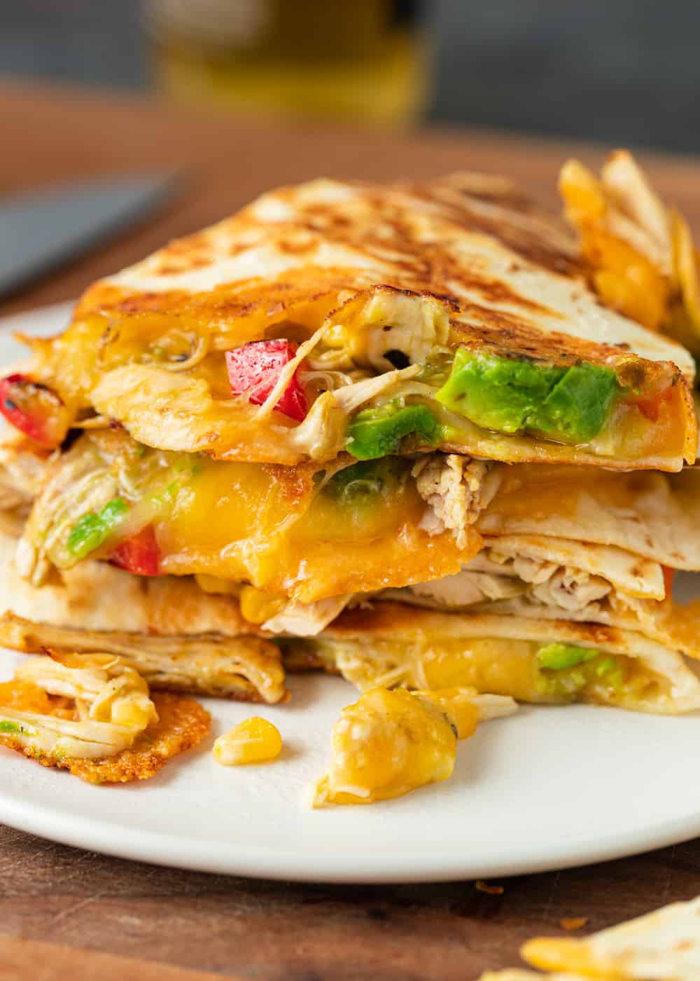 stack of crispy chicken quesadillas with lots of melted cheese, sitting on a plate