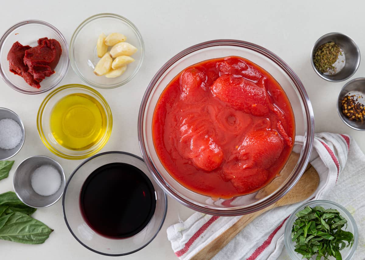 ingredients in prep bowls to make Italian tomato marinara recipe