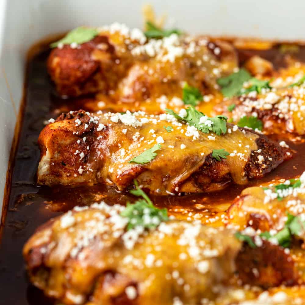 Mexican baked chicken breasts covered in enchilada sauce and cheese