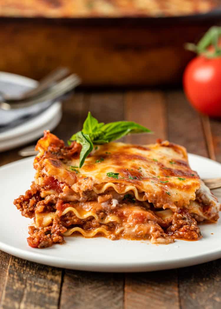 serving of sausage lasagna with bechamel on white plate