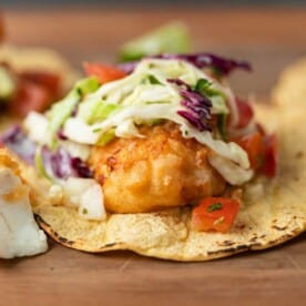close up of fried fish taco with cabbage slaw