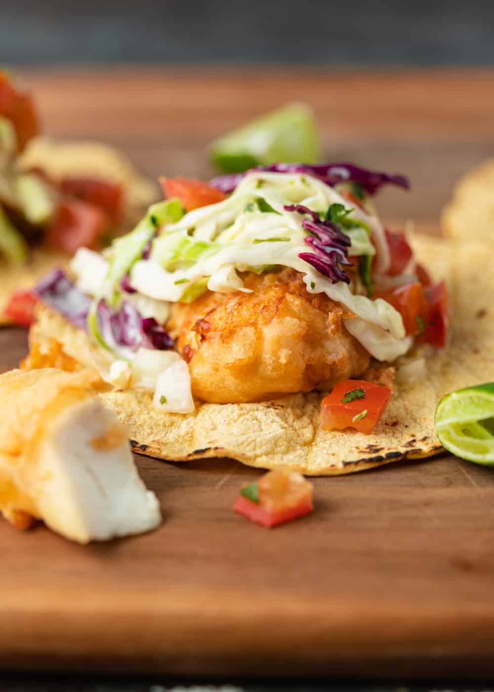 battered fish tacos on corn tortilla topped with crunchy purple slaw