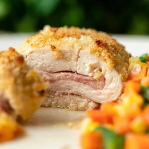 side view shows inside of baked chicken cordon bleu