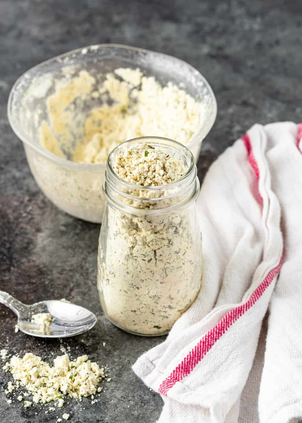 spoon of dry ranch dressing mix with jar and bowl