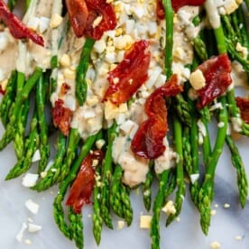 crispy prosciutto crumbled on asparagus with chopped egg and tarragon sauce