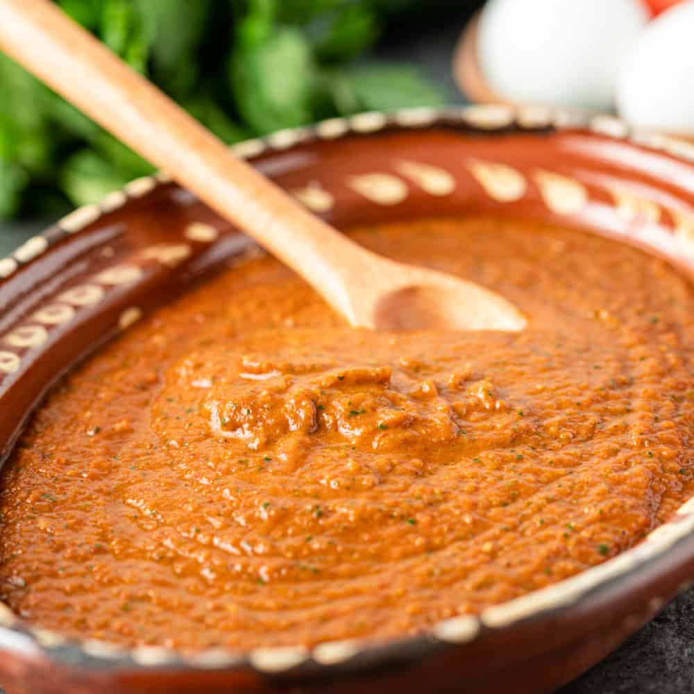 Ranchero sauce in large bowl with wooden spoon