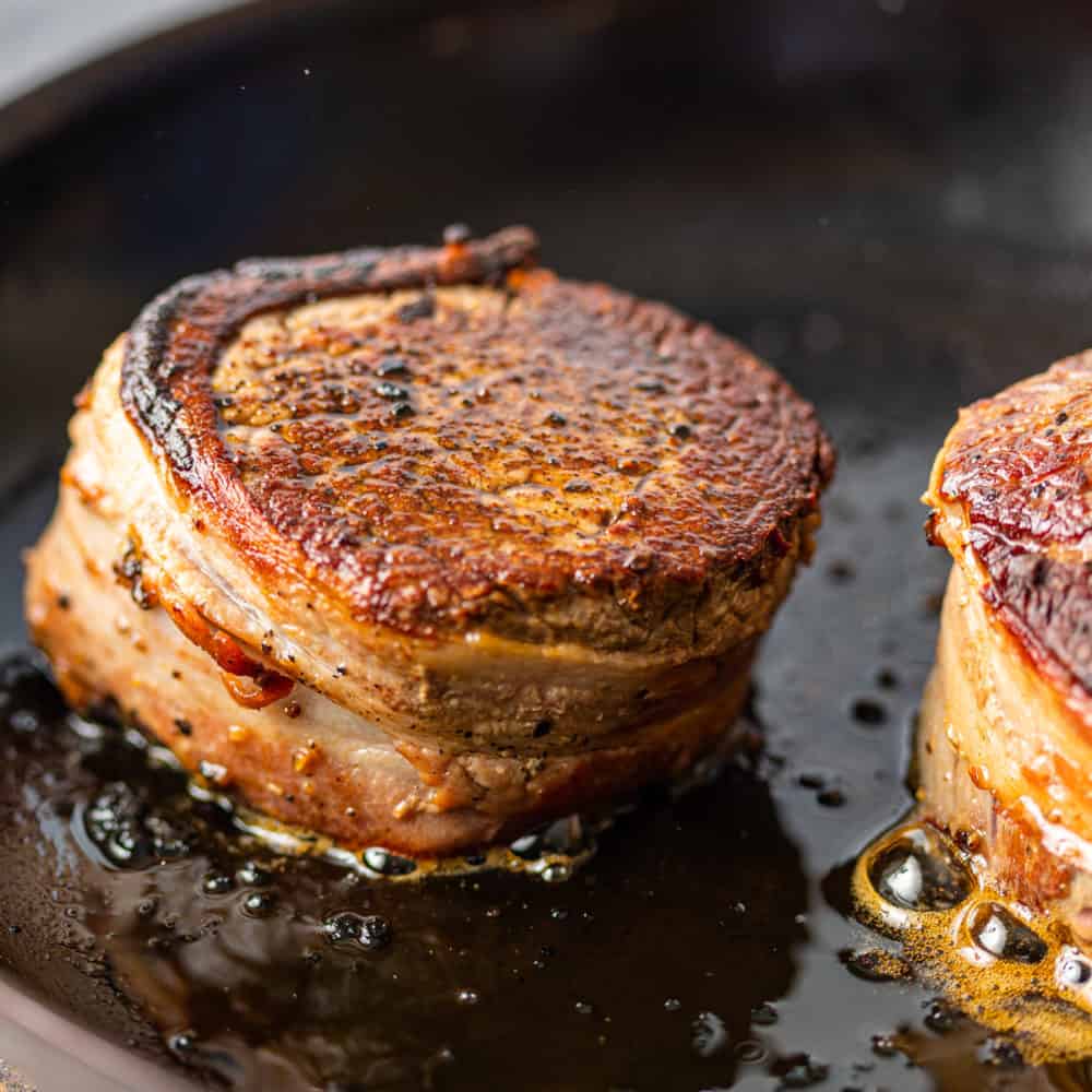 bacon wrapped filet mignon in cast iron skillet