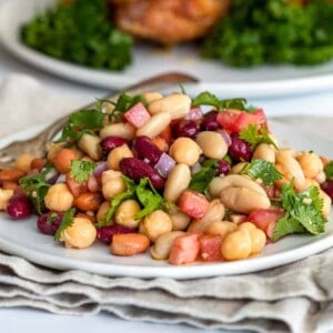 cold 4 bean salad with spicy vinaigrette on white plate