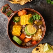 overhead image: bowl of caldo de res (vegetable beef soup)