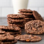 stacks of homemade chocolate cookies on counter
